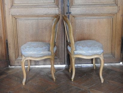 Pair of chairs in natural wood, molded and...