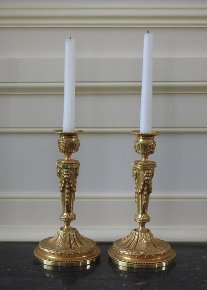 Pair of ormolu torches decorated with garlands...