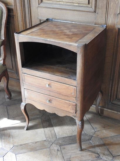 An oak table with an inlaid top forming a...