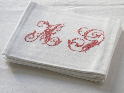 Nine large napkins with A.G. in red.