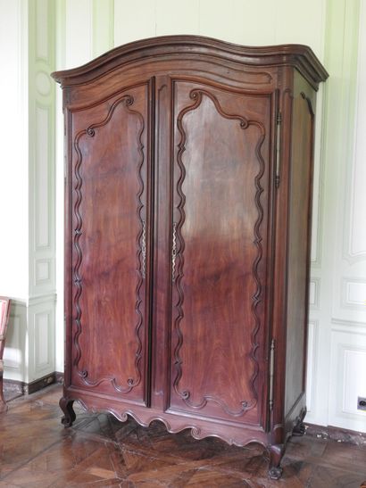 Mahogany cabinet molded and carved with cornice...