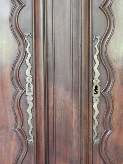 Mahogany cabinet molded and carved with cornice...