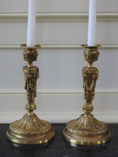 Pair of ormolu torches decorated with garlands...