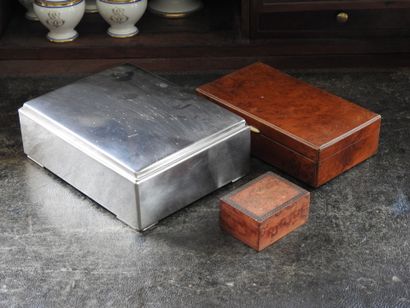 Meeting of three boxes, one in metal, the...