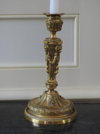 Pair of ormolu torches decorated with garlands...