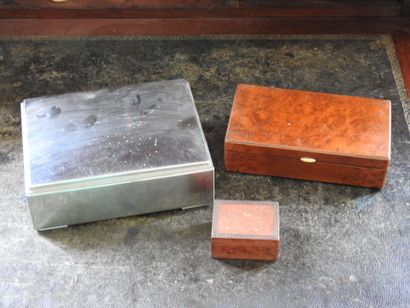 Meeting of three boxes, one in metal, the...