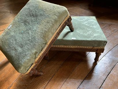 Pair of carved molded wood footrests resting...