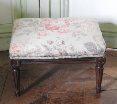 Rectangular footrest in natural wood resting...