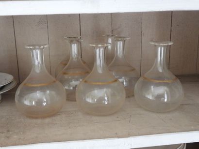 Suite of seven glass decanters with gilded...