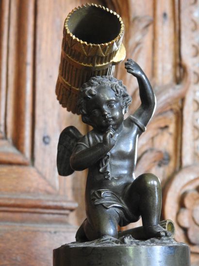A patinated and gilded bronze match holder...