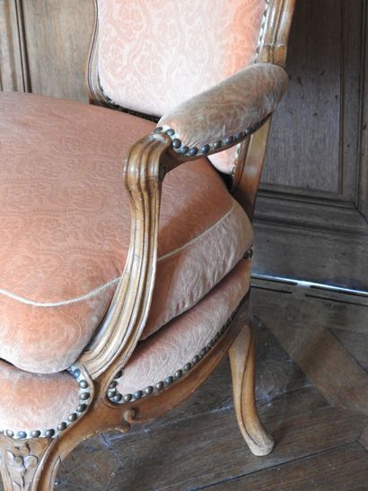 A cabriolet armchair in natural wood molded...