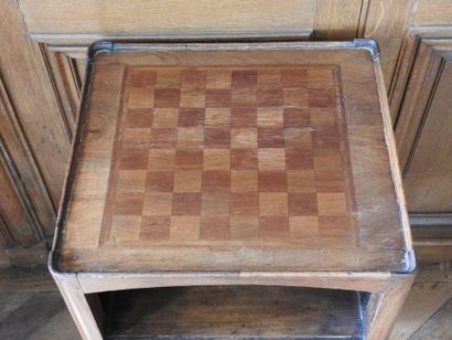 An oak table with an inlaid top forming a...