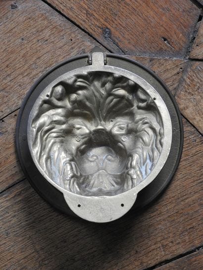 Suite of four bronze knockers with lion heads....