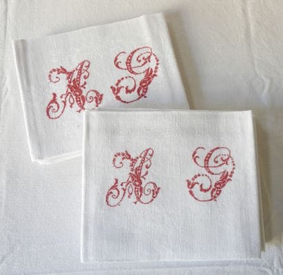 Nine large napkins with A.G. in red.