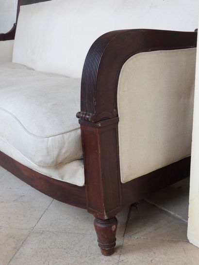 Large mahogany sofa, the ribbed armrests...