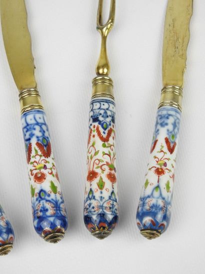 Set of three knives and two forks with two...