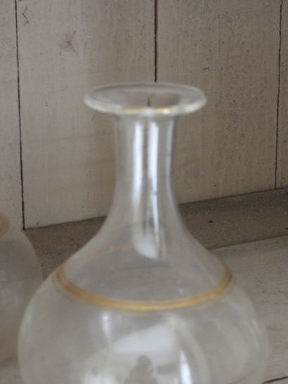 Suite of seven glass decanters with gilded...