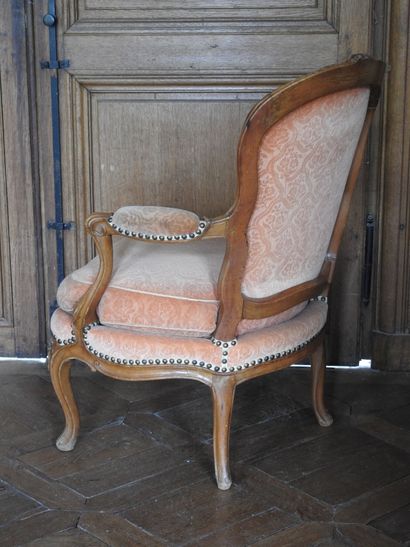 A cabriolet armchair in natural wood molded...
