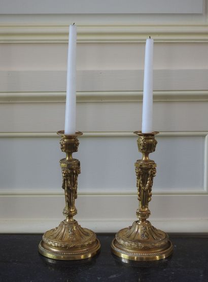 Pair of ormolu torches decorated with garlands...