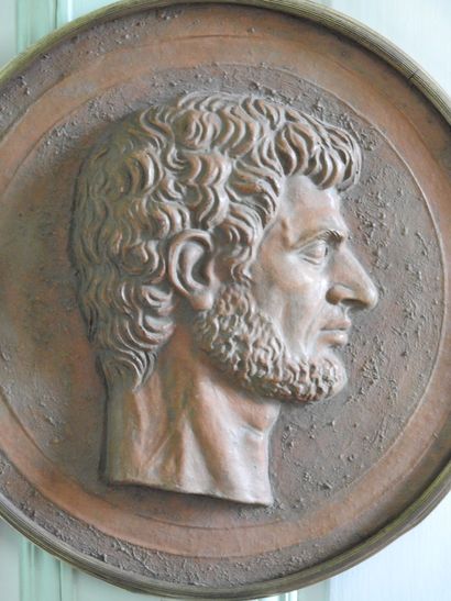 Terracotta medallion encircled with gilt...