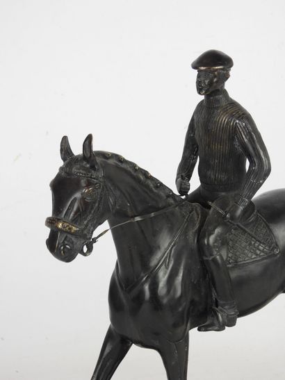 RIDER ON HORSEBACK. Bronze group with brown...