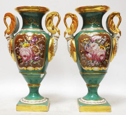 Pair of porcelain vases on a green background...
