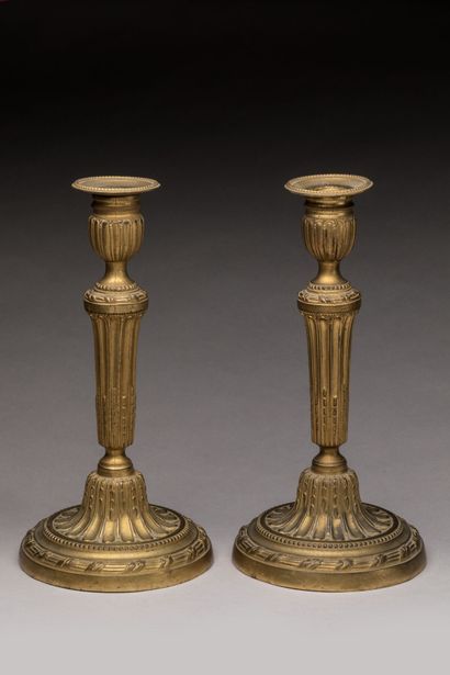 PAIRE DE BOUGEOIRS in chased and gilt bronze....