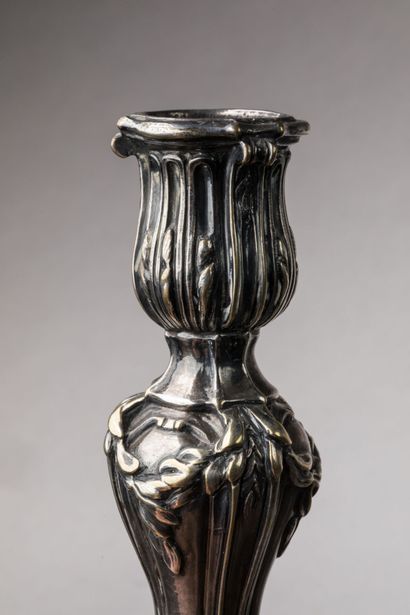 A silver-plated bronze CANDLE-HOLDER decorated...