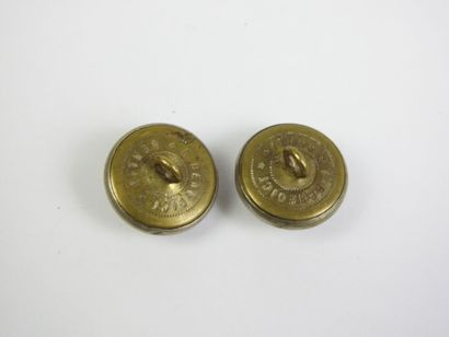 DELIVERY BUTTON. OO. Pair of outfit buttons...