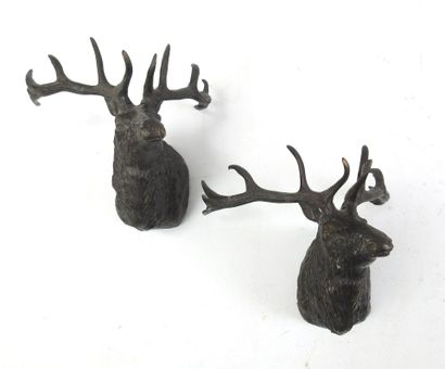 TWO DEER HEADS in brown patina bronze. Presented...
