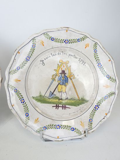 NEVERS: Three earthenware scalloped rim plates...