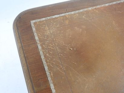 A mahogany desk resting on a base joined...