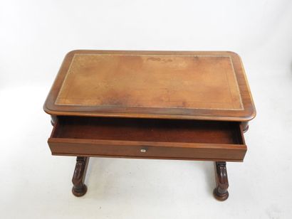 A mahogany desk resting on a base joined...