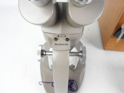 BULOVA: Microscope in grey lacquered metal....