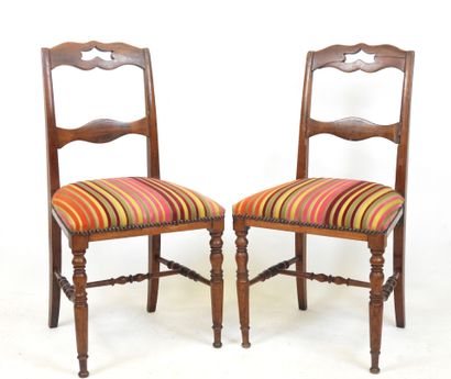 PAIR OF CHAIRS in carved wood, the seat covered...