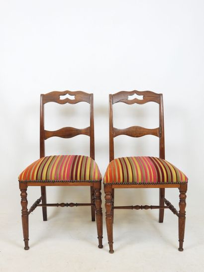 PAIR OF CHAIRS in carved wood, the seat covered...
