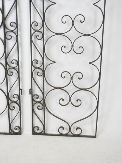 PAIR of black-tinted and gilded wrought-iron...