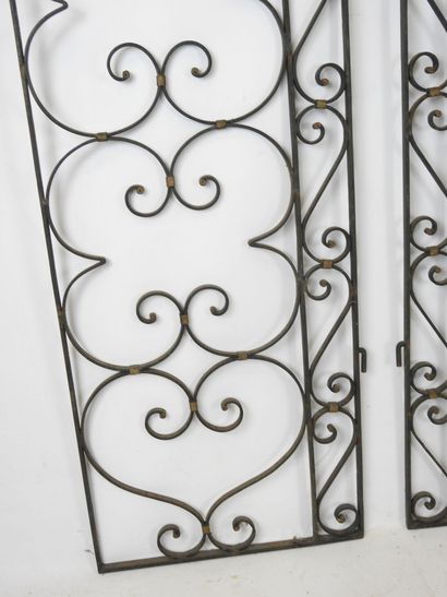 PAIR of black-tinted and gilded wrought-iron...