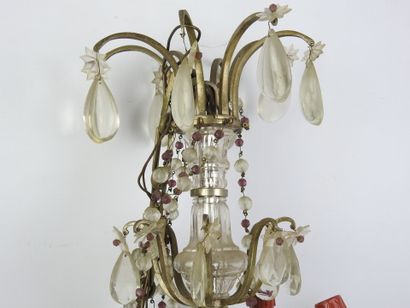 Metal eight-arm chandelier adorned with pendants....