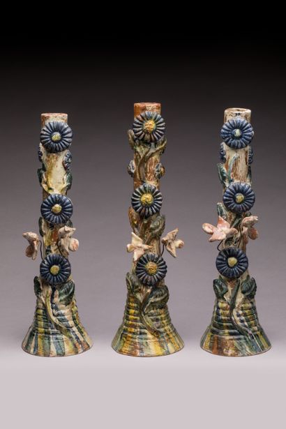 POPULAR ART: Three glazed terracotta candleholders...