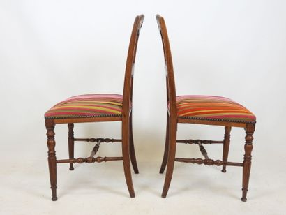 PAIR OF CHAIRS in carved wood, the seat covered...