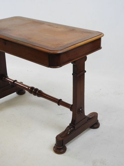 A mahogany desk resting on a base joined...