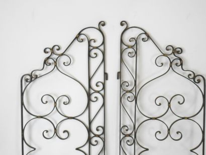 PAIR of black-tinted and gilded wrought-iron...