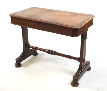 A mahogany desk resting on a base joined...