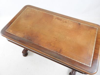 A mahogany desk resting on a base joined...