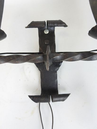Wrought-iron sconce with two arms forming...