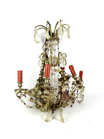 Metal eight-arm chandelier adorned with pendants....