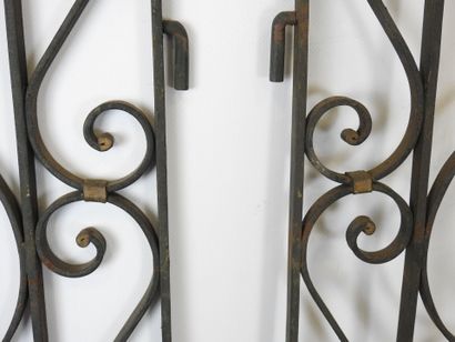 PAIR of black-tinted and gilded wrought-iron...