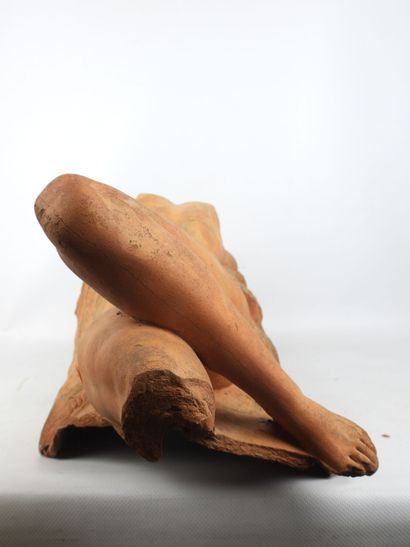 Nude woman lying on a sheaf of wheat, terracotta....