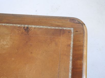 A mahogany desk resting on a base joined...